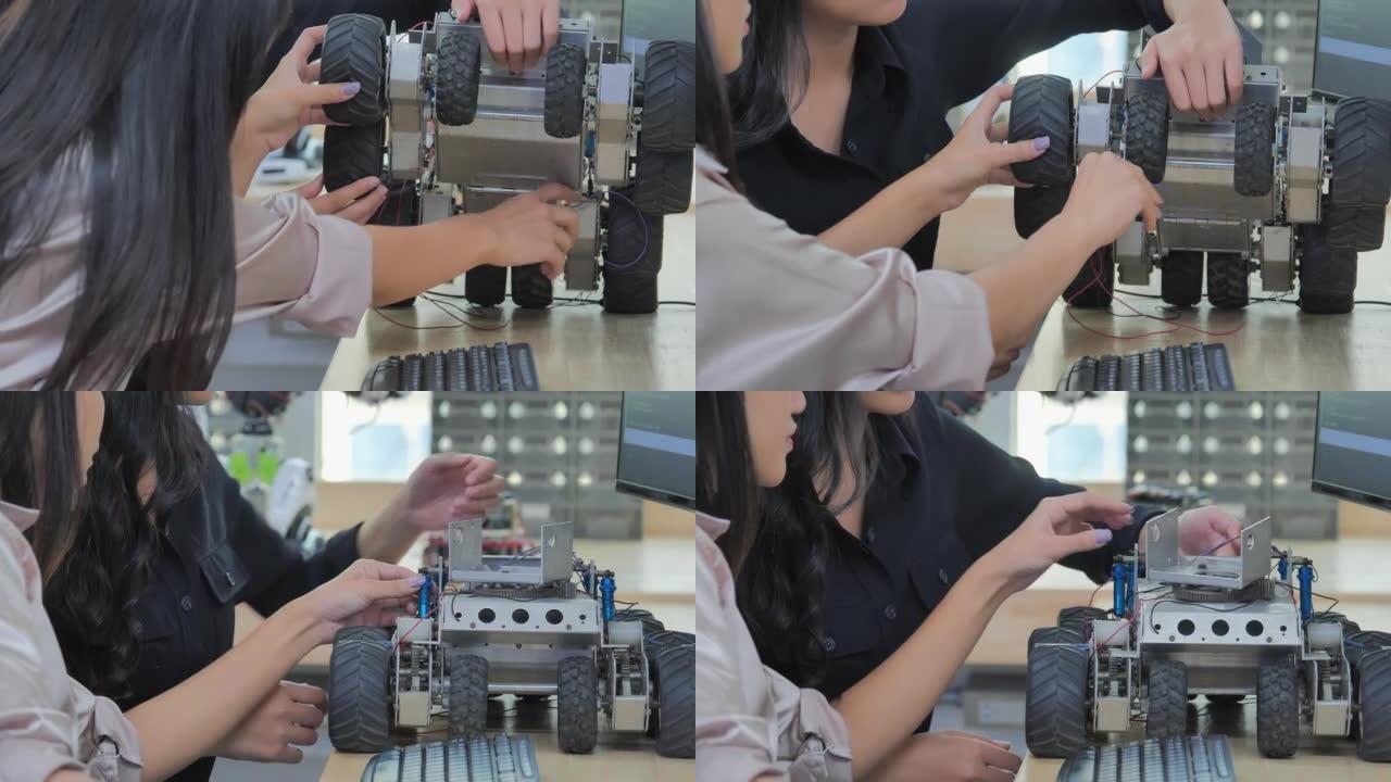 接近两个少年女孩的亚洲种族，在STEM教育科学工程课上学习编程机器人车辆。