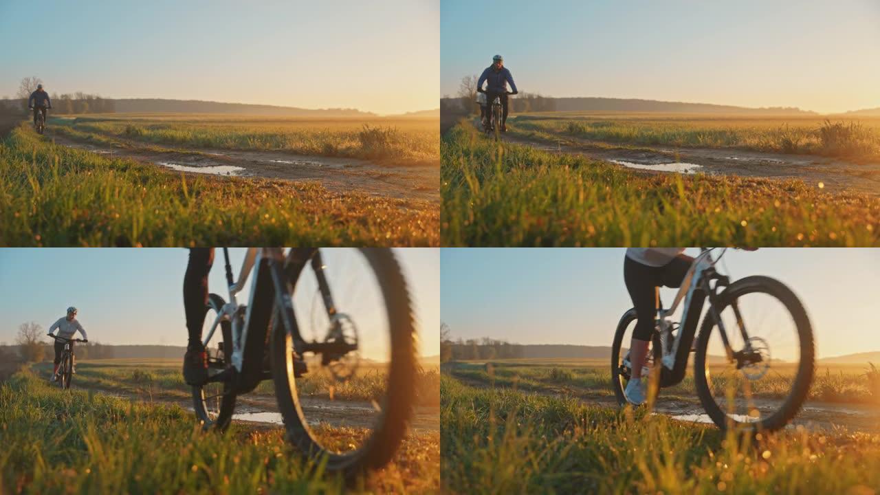 日落时分，SLO MO MTB骑自行车的人在草地之间的小路上骑自行车