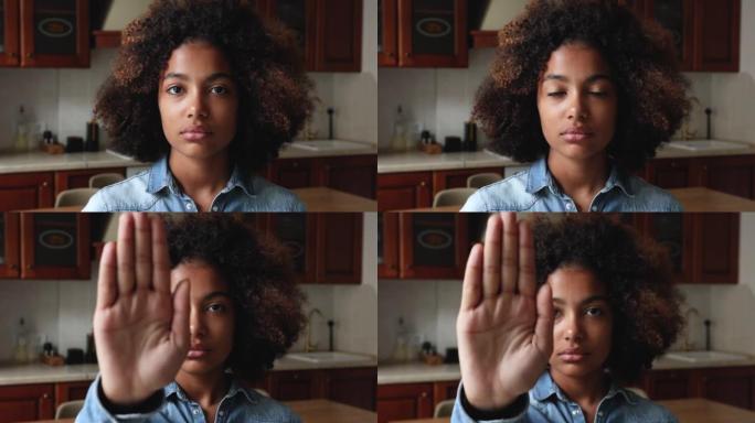 年轻的非洲妇女举起手掌做停止手势