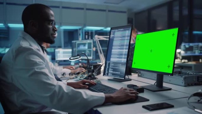 现代电子设施: 科学家，工程师在绿色色度键屏幕计算机上工作。工业PCB、硅微芯片、半导体、电信设备的