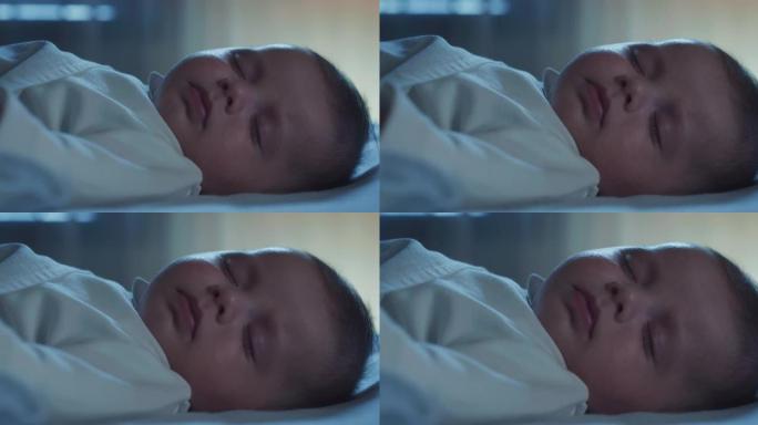 可爱的新生婴儿的真实特写镜头是晚上在托儿所里用柔软的毯子安静舒适地睡觉的时候睡觉。儿童、婴儿、美梦、
