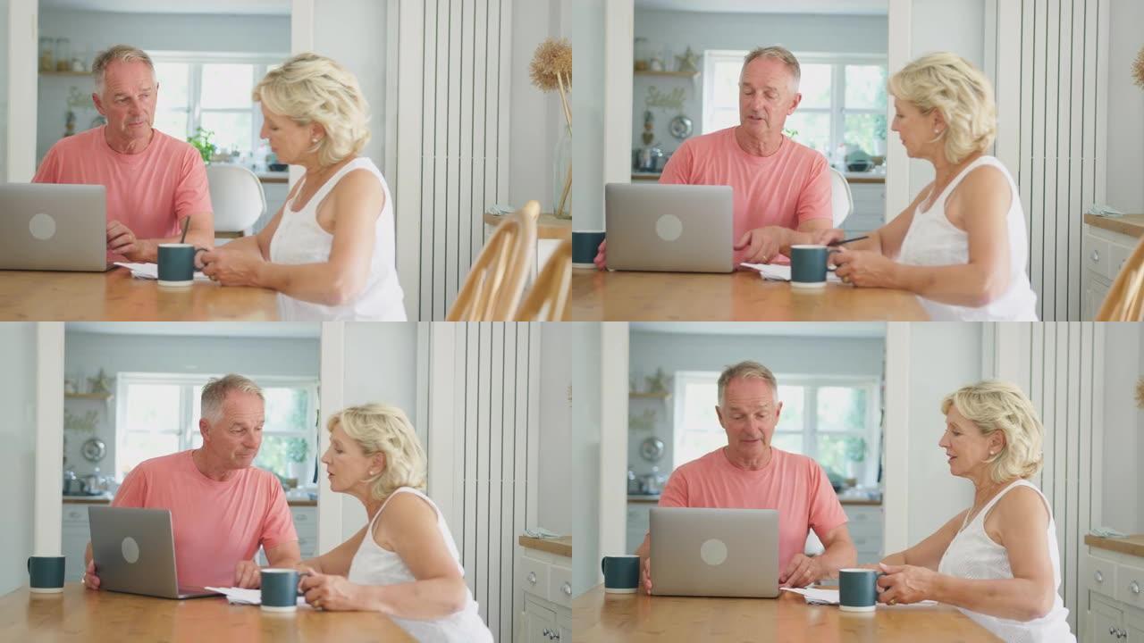 退休的高级夫妇在家中使用笔记本电脑在网上购物或检查个人财务状况