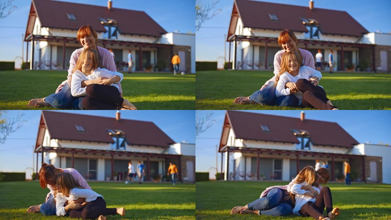 SLO MO慈爱的母亲和她的女儿在绿色的草坪上玩得开心