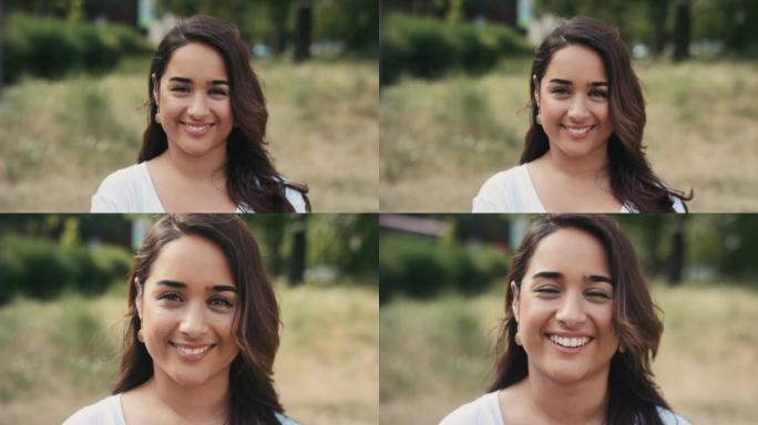 公园背景下一个快乐的年轻女子的4k录像