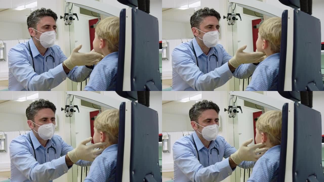 儿科医生在诊所检查男孩的喉咙