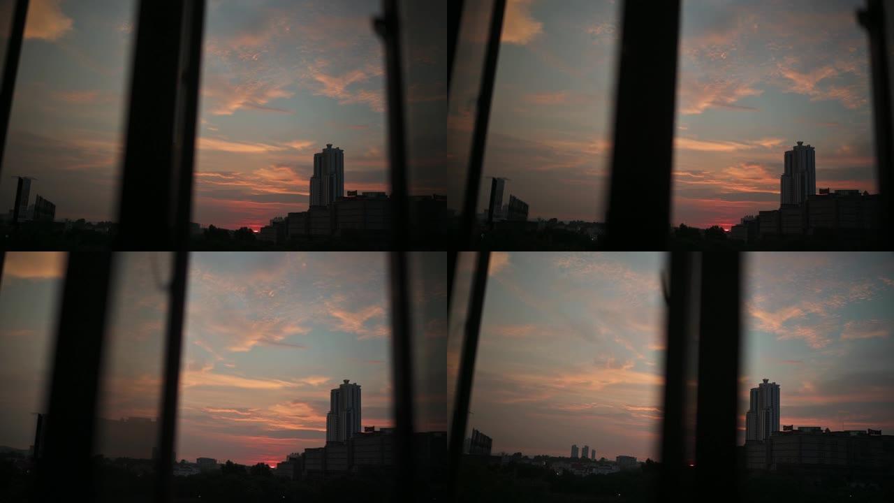 日落透过窗户看城市，日落在窗户上反射