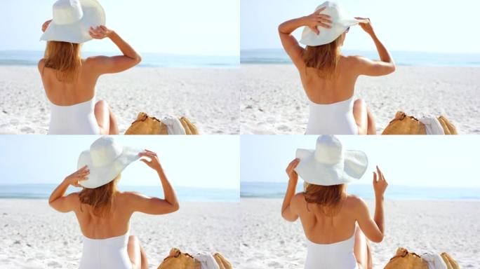 4k视频片段，一名妇女在海滩上欣赏美景