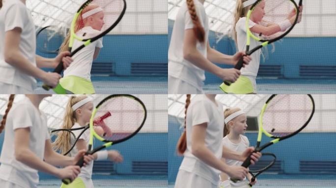 小女孩在球场上练习网球