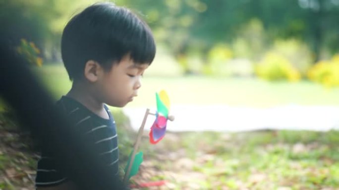 带纸风车的小男孩小孩风车土地