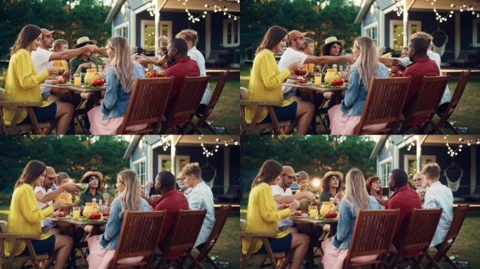 一群多种族的人在户外晚餐时玩得开心，互相交流，吃素食。在温暖的夏日，亲戚和朋友聚集在他们的家外。