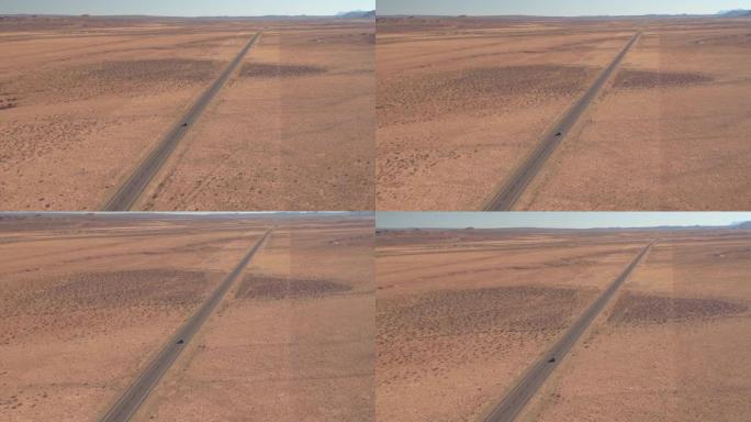 航拍:飞越荒芜的平原上空的州际公路。