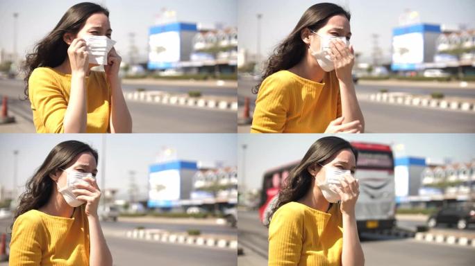 街头保护面具的亚洲女性咳嗽