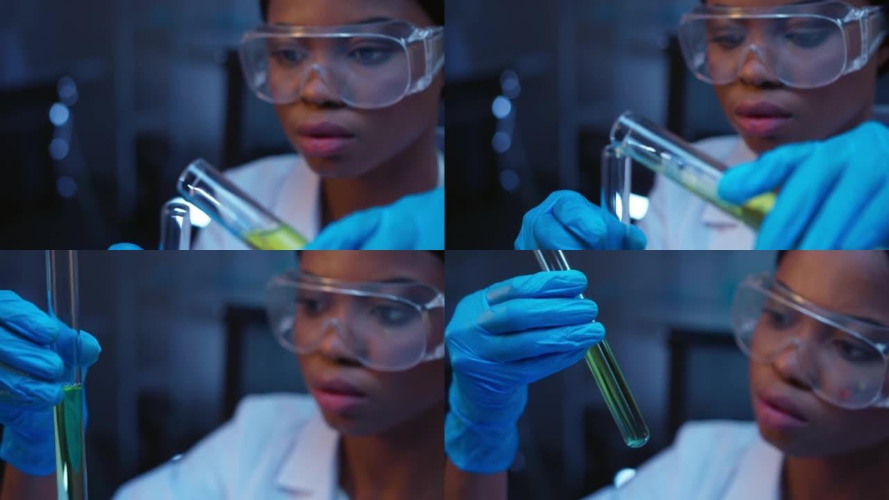 一位年轻的深色皮肤化学家戴着防护眼镜和一件实验室外套，用绿色液体在玻璃试管中进行化学反应