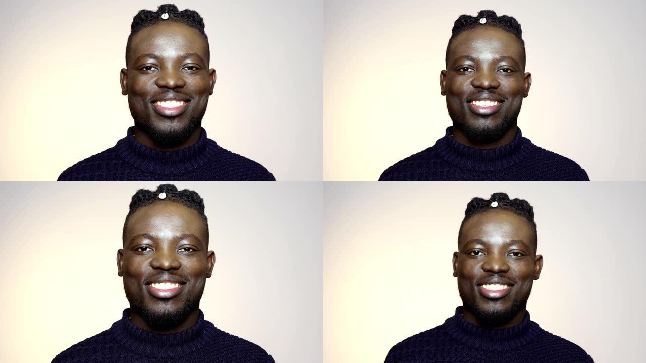 非洲年轻人转向相机并微笑的肖像