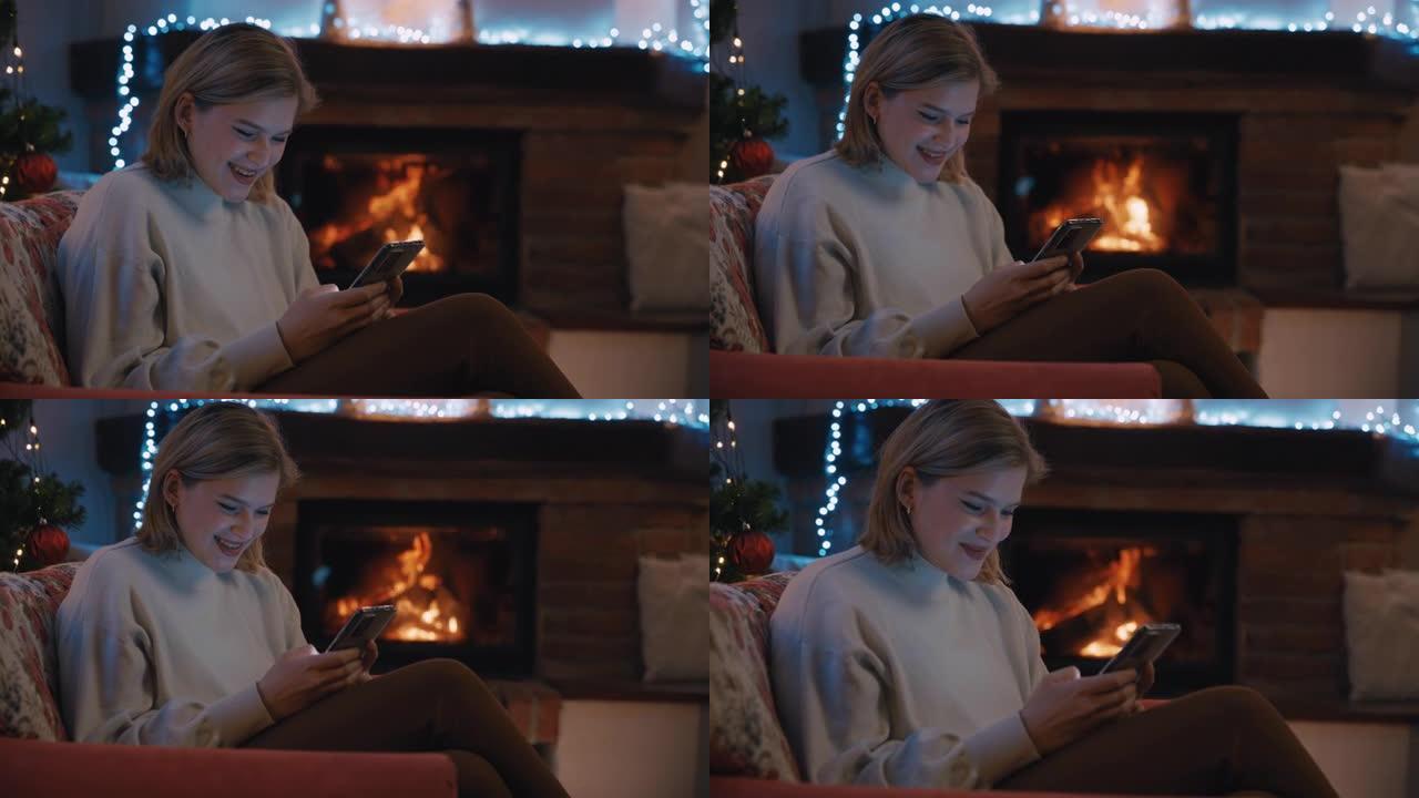 SLO MO DS Happy woman在圣诞节假期装饰的温暖客厅中使用智能手机