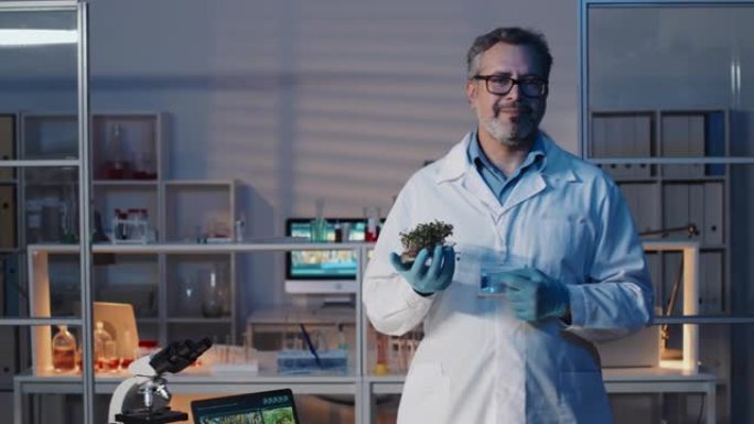 成熟的成功科学家，绿色幼苗站在实验室