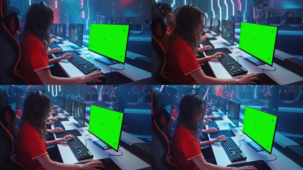 职业女孩玩电脑游戏，在锦标赛上显示绿屏。专业游戏玩家组成的多元化Esport团队在模拟视频游戏中进行
