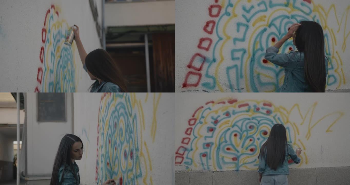 女性涂鸦艺术家喷涂墙壁