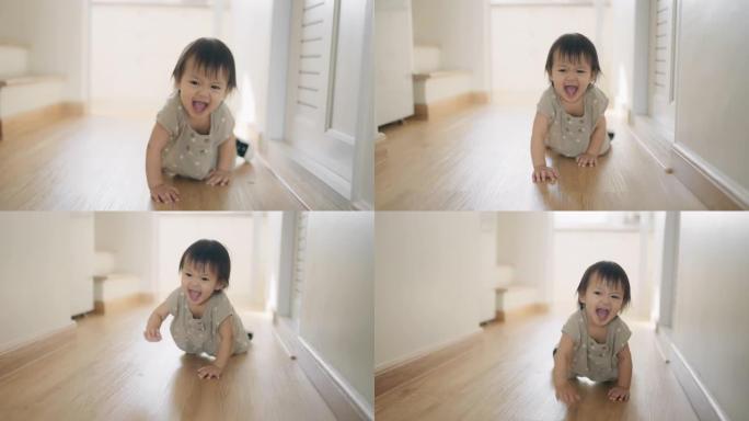 小女孩在她的房子里快乐地练习走路和爬行。