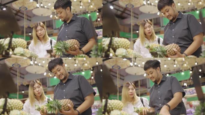 亚洲夫妇在零售店选择菠萝