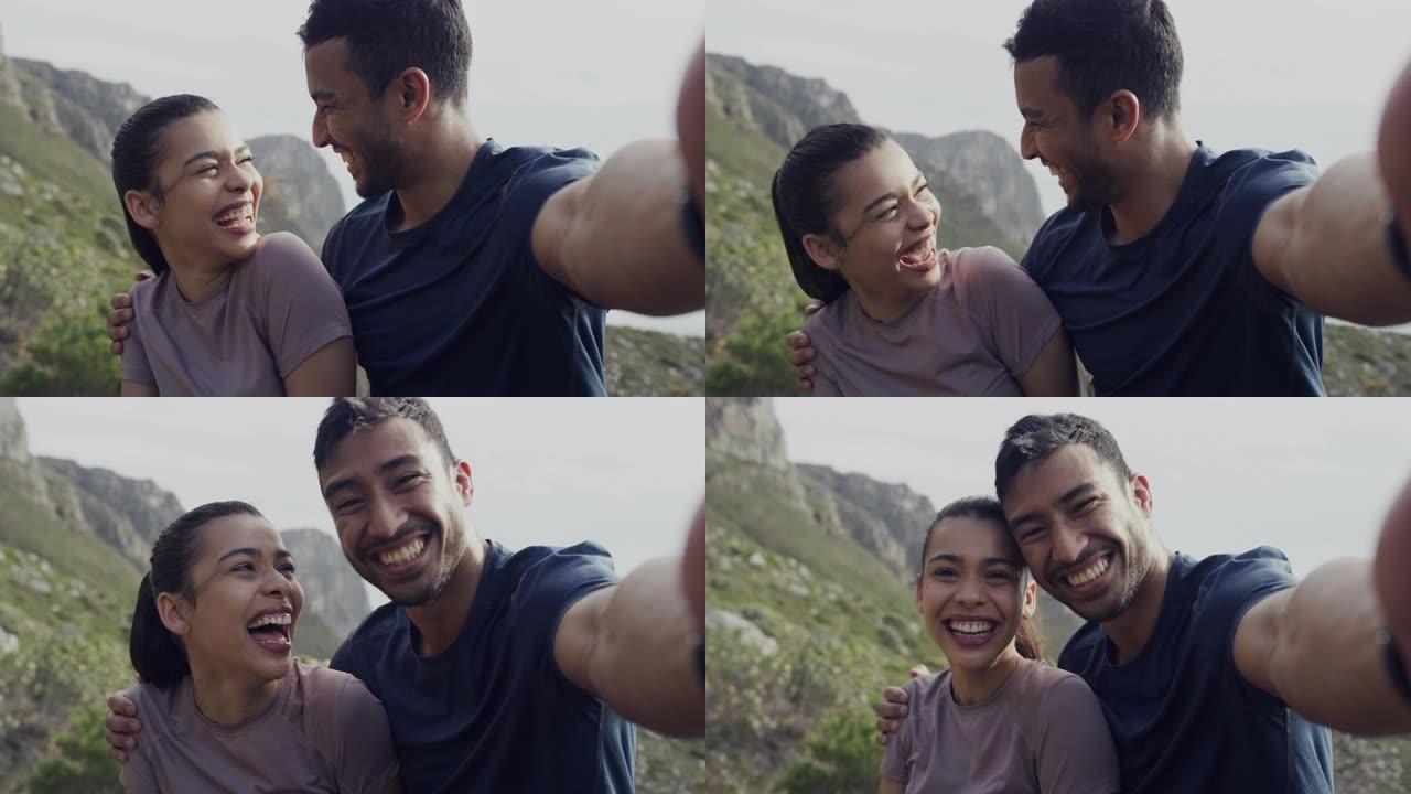 4k视频片段，一对年轻夫妇在外面的山脉远足时拍照