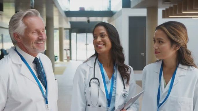 医务人员穿着白色大褂和数字平板电脑在医院开会的肖像