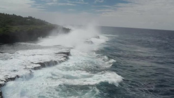 海浪的航拍在暴风雨来临前坠入荒岛的岩石悬崖。