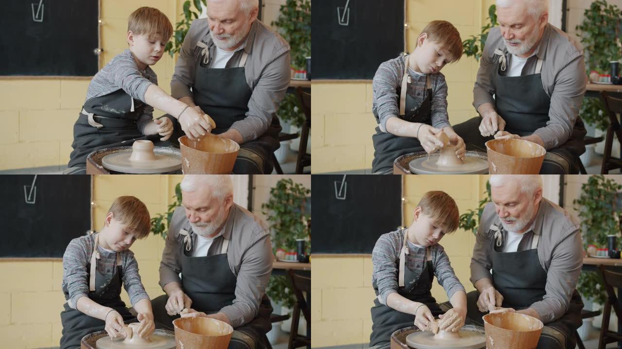 勤奋的孩子与祖父一起在投掷轮上制作陶瓷的慢动作