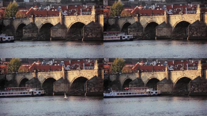 查尔斯桥 (Charles Bridge) 的景色，这是一座中世纪的石拱桥，在日落时穿越捷克共和国首