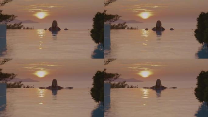 SLO MO女人从无边泳池欣赏美景