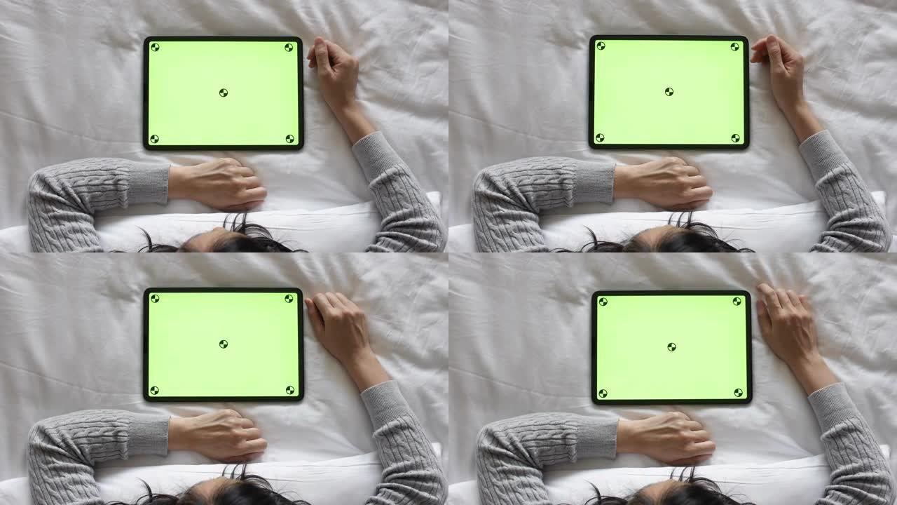 使用数字平板电脑绿屏的女性俯视图