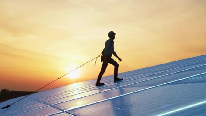 男性维护工程师走上发电的工业太阳能电池板。职业男子穿着安全设备检查绿色能源。VFX动画图形概念。