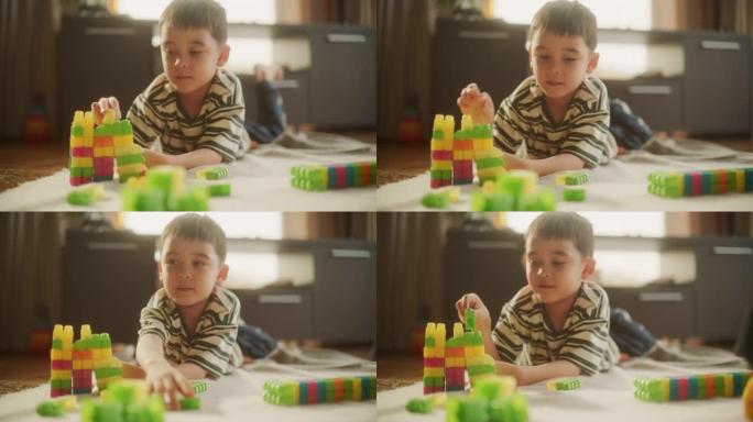 白天，可爱的亚洲男性孩子在房间里玩彩色积木的肖像。创意和专注的小男孩使用逻辑和技能制作玩具屋。他很高