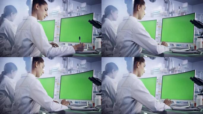实验室团队使用计算机。显示器上的绿色屏幕