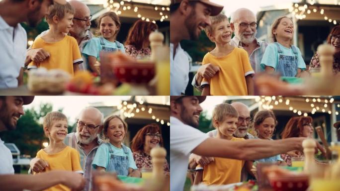 快乐的高级祖父与他的孙子们交谈并玩得开心，在户外晚餐时将他们抱在腿上，并提供食物和饮料。成年人和孩子