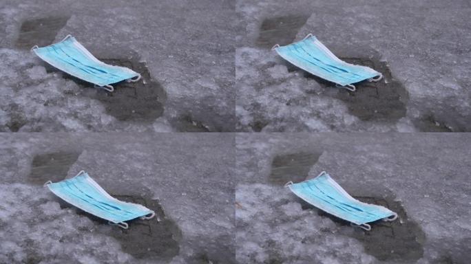 特写: 在冠状病毒大流行期间，人们扔掉了防护口罩。