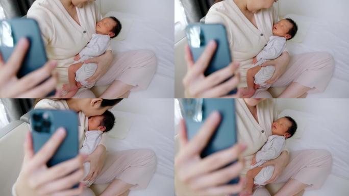 特写美女妈妈抱着可爱的小新生儿在手机上做视频通话。技术