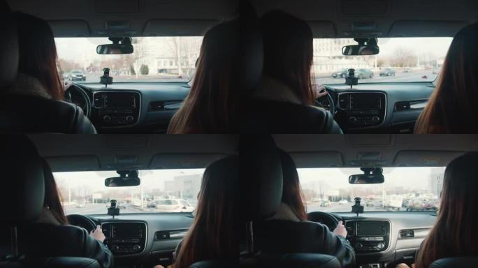 城市驾驶压力。从车内看，两名妇女在繁忙的大城市街道上乘坐私人车辆时交谈。