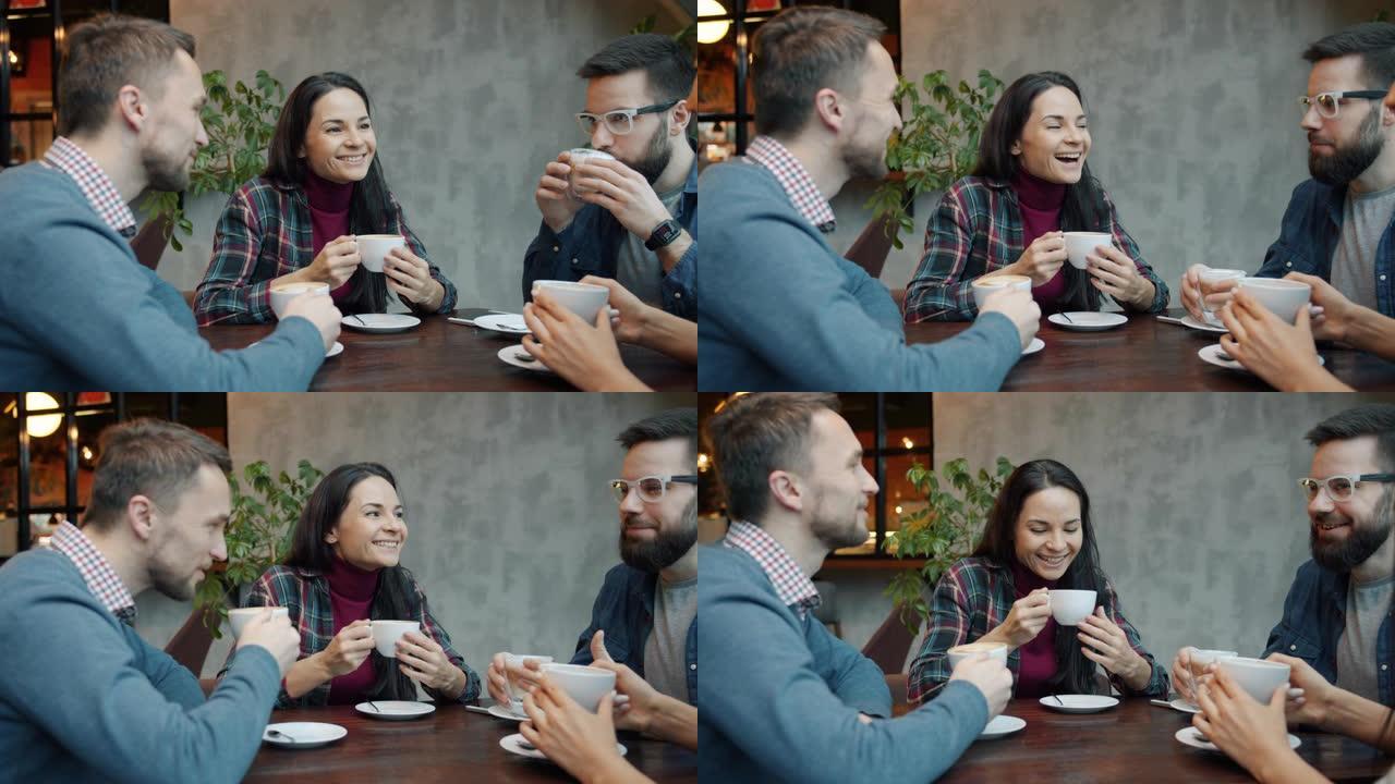 快乐的朋友男女在咖啡馆的餐桌上聊天和喝咖啡