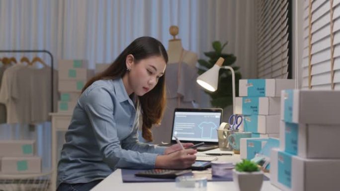 忙碌的亚洲小企业主企业家成功女人夜间工作。