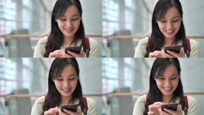 亚洲女性在城市使用智能手机进行社交媒体