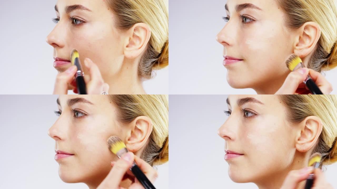 4k视频片段，一名年轻女子在工作室背景下化妆