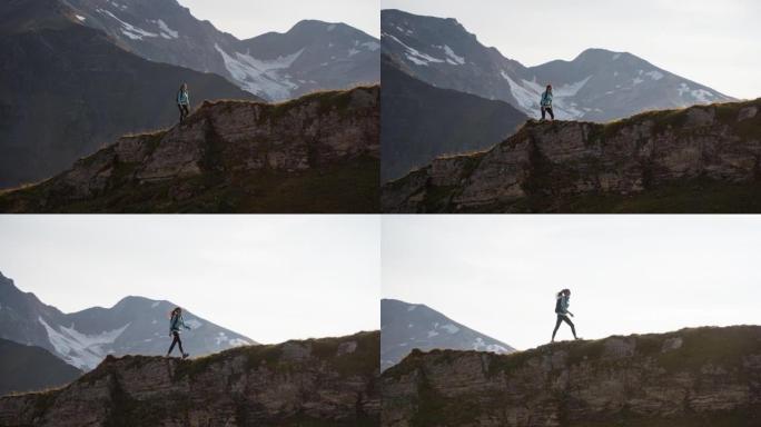 女性徒步旅行者走在山脊小径上，俯瞰山谷