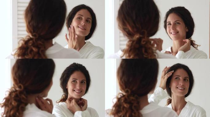 35岁的女人照镜子欣赏健康完美无瑕的面部皮肤