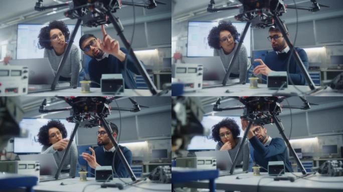黑人男性工程师将笔记本电脑放在屏幕上，与他的女同事就无人机设计进行头脑风暴。无人机设计概念中的创新技