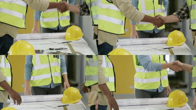 在建筑工地的一次会议上，一群无法识别的建筑商握手的4k视频片段