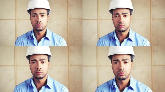 一名年轻建筑工人在工作时戴着安全帽的4k录像