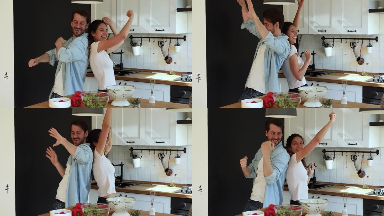 喜出望外的年轻已婚夫妇在厨房跳舞。