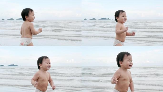 快乐的亚洲小男孩儿子学习在热带海滩上散步，在沙滩上沿着日落的边缘玩得开心。