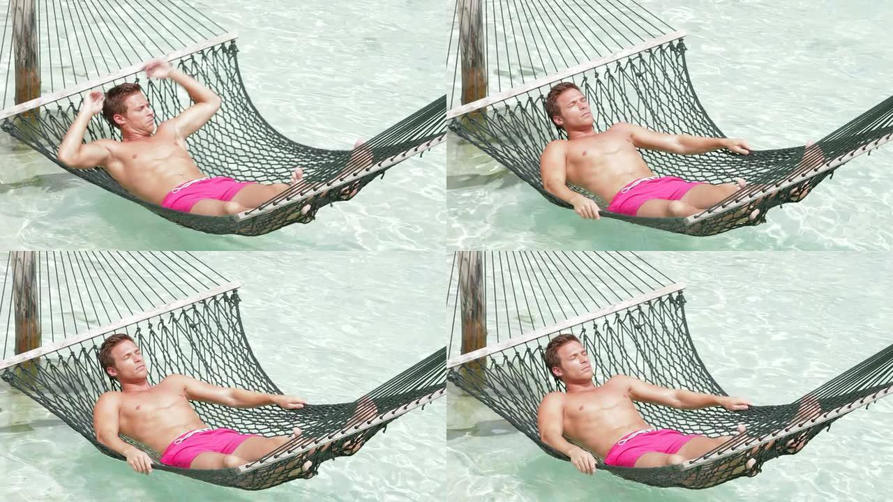 男子在海滩吊床上放松